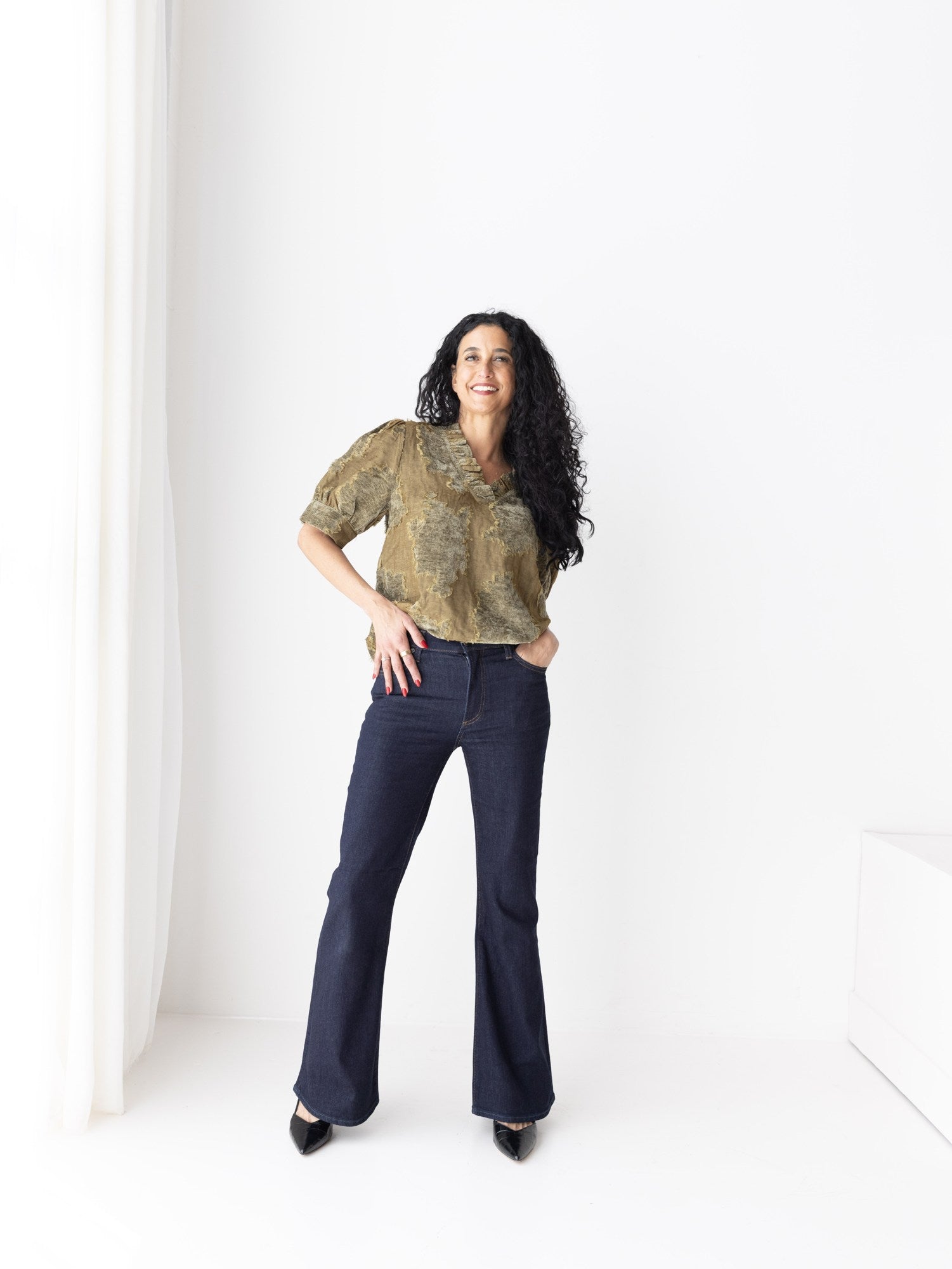 Textured olive blouse styled with dark flared denim