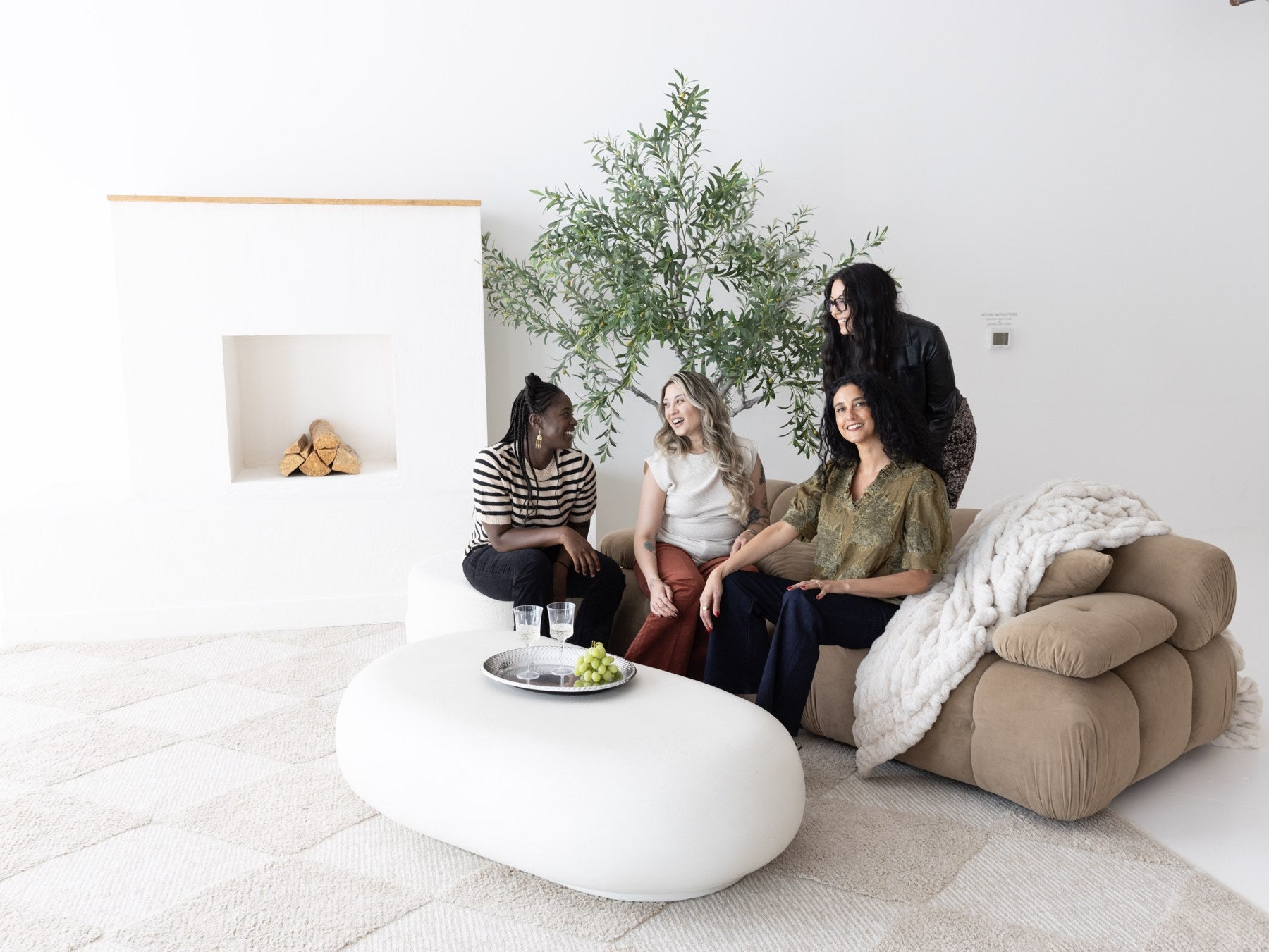 Friends gathering around the brown studio sofa