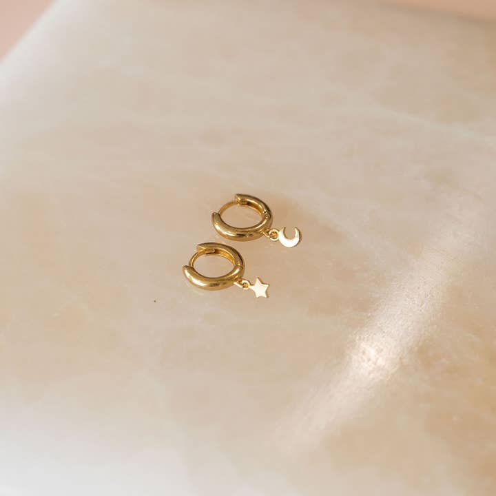 The Land of Salt Star and Moon Huggie Hoops in Gold